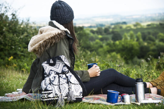 A solo female camper enjoying scenic beauty near her campsite